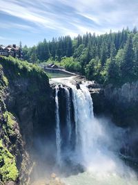 Scenic view of waterfall against sky