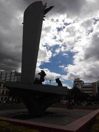 Low angle view of statue against sky in city