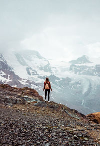 Woman with backpack on mountain background. top of gornergrat, zermatt, swiss. hiking in alps