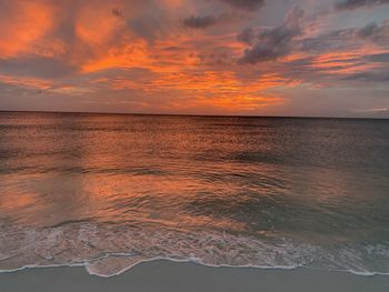 Scenic view of sea against orange sky