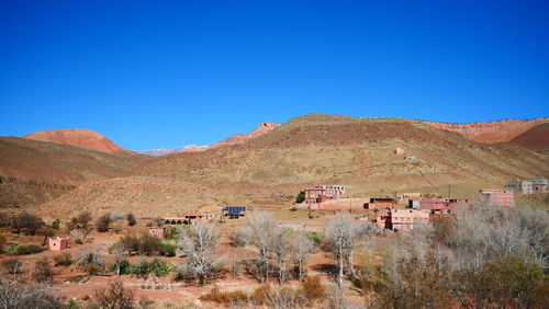 Scenic view of mountains against clear blue sky