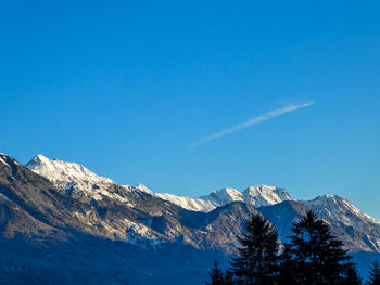 Scenic view of snowcapped mountains against clear blue sky