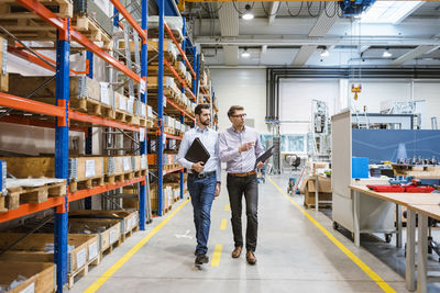 Two men walking in factory