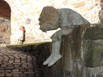 Man walking on stone wall