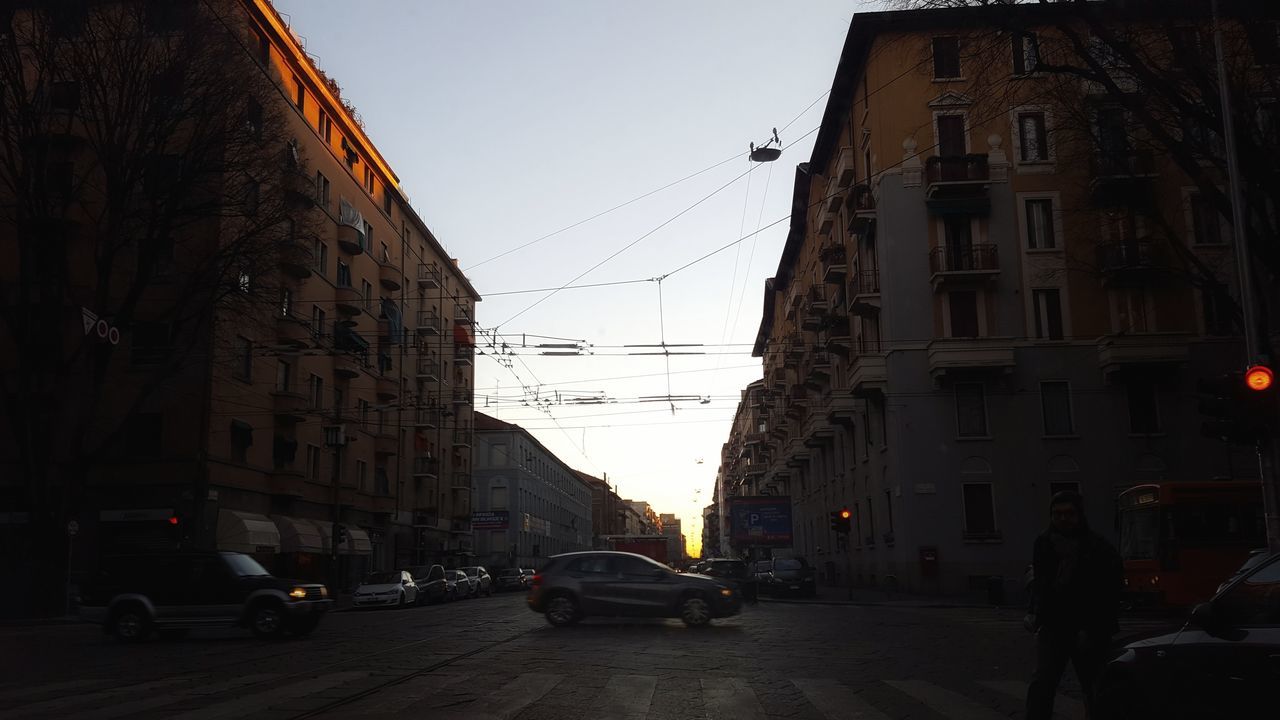 CARS ON ROAD AGAINST SKY