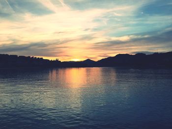 Scenic view of lake against sky during sunset