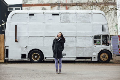 Full length of woman standing on road