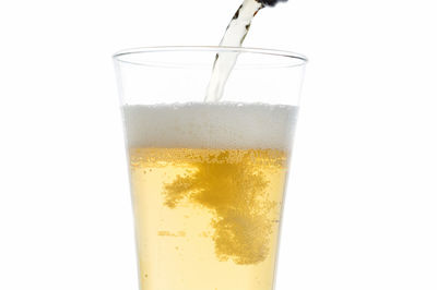 Close-up of beer glass against white background