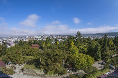 High angle view of trees and buildings against sky