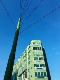 Low angle view of building against clear blue sky