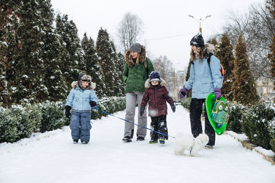 Outdoors winter activities for family, friends. happy family, friends, two women, two boy kids and