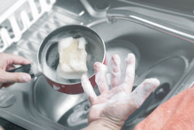 Daily life man dish washing at kitchen