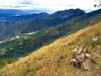 Scenic view of mountains against cloudy sky