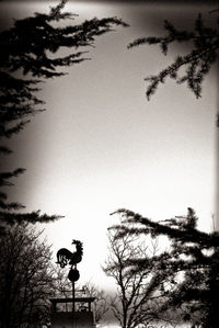 Low angle view of silhouette statue against clear sky