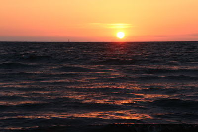 Scenic view of sea against romantic sky at sunset