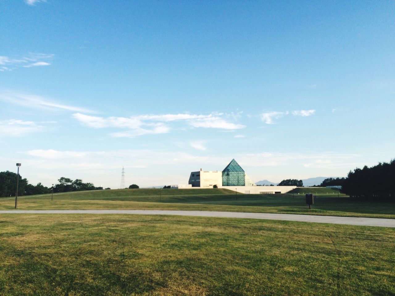 grass, building exterior, architecture, built structure, sky, field, blue, grassy, green color, tree, lawn, cloud, cloud - sky, house, day, nature, landscape, outdoors, no people, tranquility