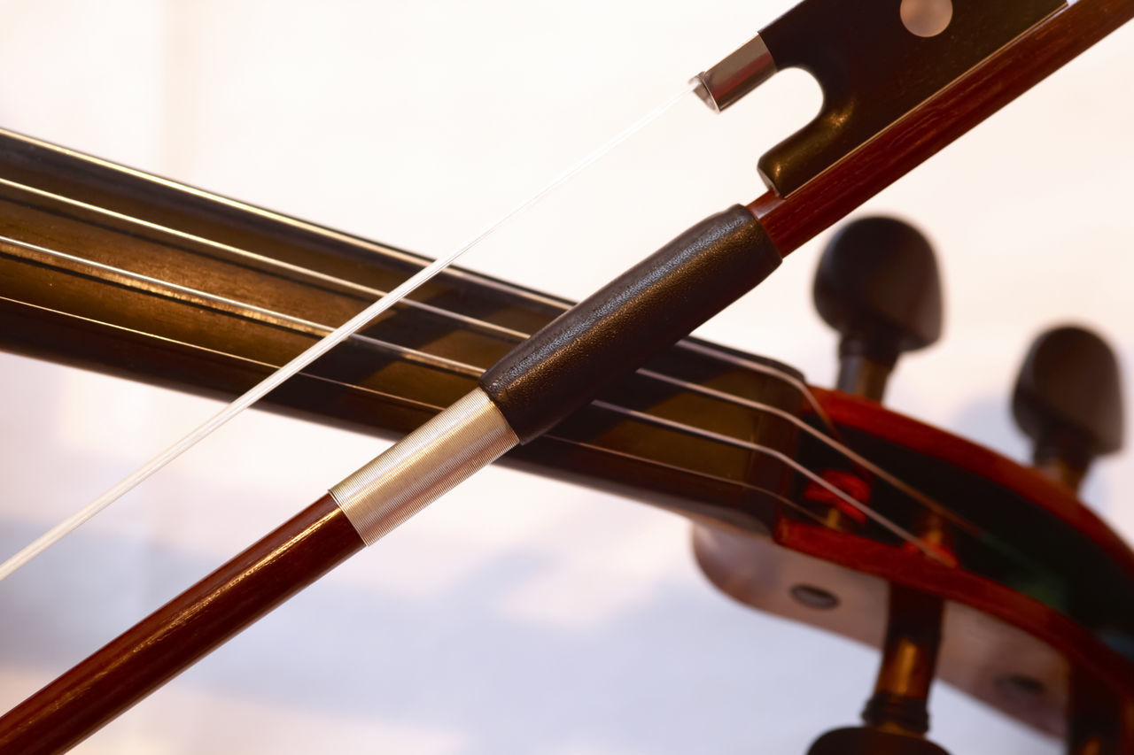 LOW ANGLE VIEW OF PLAYING GUITAR AGAINST SKY