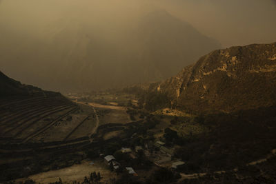 Scenic view of landscape against sky during foggy weather