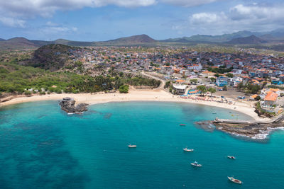 High angle view of sea and mountains against sky