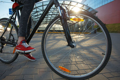 Low section of person riding bicycle on street