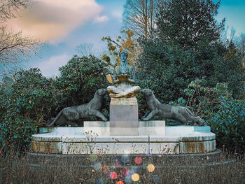 Low angle view of statue against trees