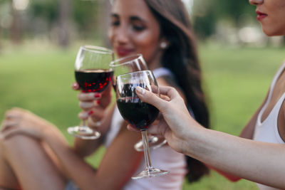 Midsection of woman drinking glass