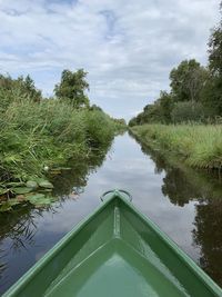 Boat in canal against sky