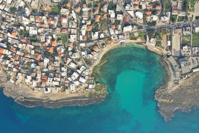 High angle view of swimming pool by buildings in city