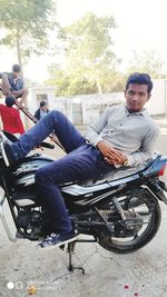 Portrait of young man sitting on motorcycle