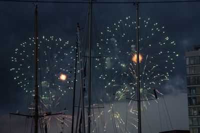 Low angle view of fireworks display against sky at night