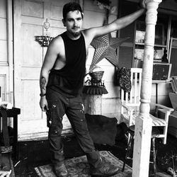 Portrait of young man standing against wall
