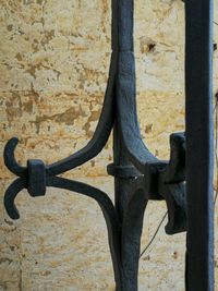 Close-up of metal fence against wall