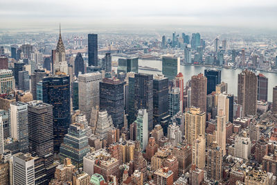 Aerial view of modern buildings in city against sky