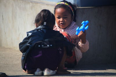 Full length of cute girl holding toy