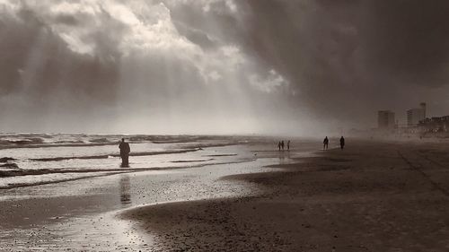 Man standing on beach against sky