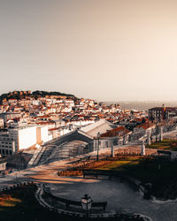 High angle view of river by buildings against clear sky