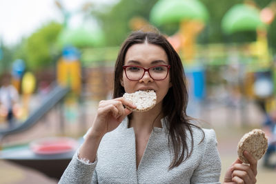 Portrait of young woman eating food