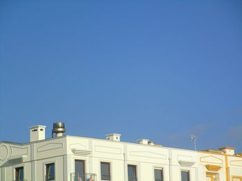 Low angle view of buildings against blue sky