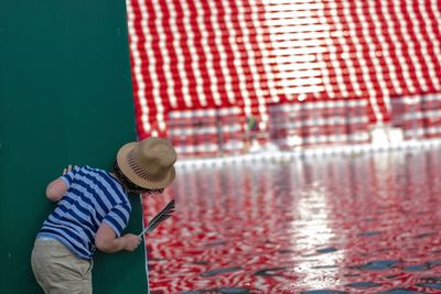 Rear view of boy standing in water