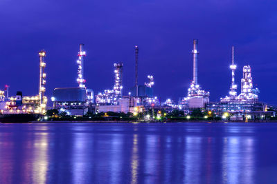 Illuminated city against sky at night