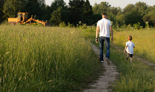 Rear view of men walking on land