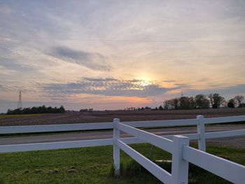 Scenic view of field against sky during sunset