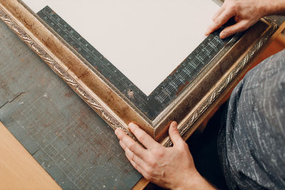 Cropped hands of man holding book