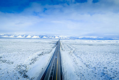 Snow covered road against sky