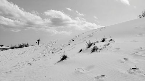 Scenic view of snow covered land against sky