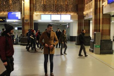 Group of people walking in illuminated city