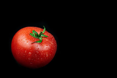 Close-up of strawberry over black background
