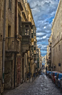 Street amidst buildings in city against sky