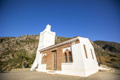 Low angle view of building against clear blue sky