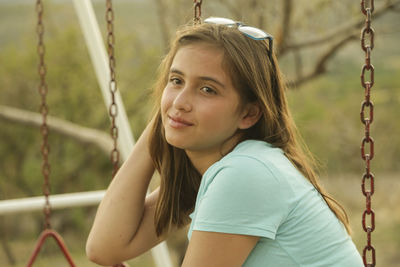 Portrait of girl on swing at playground